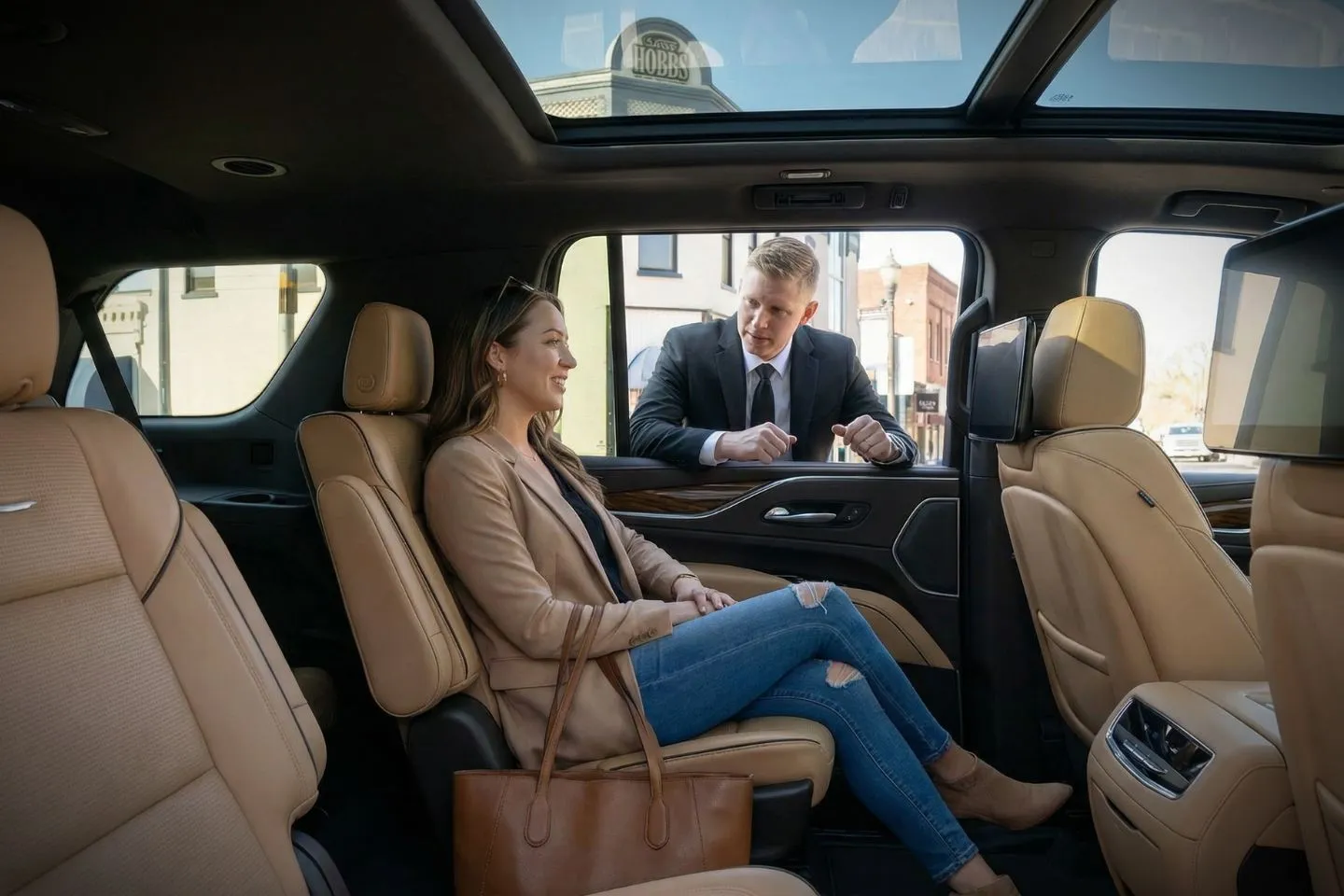 Chauffeur Service in Arkansas, AR Professional chauffeur assisting passengers into luxury vehicle in Arkansas AR chauffeur service setting