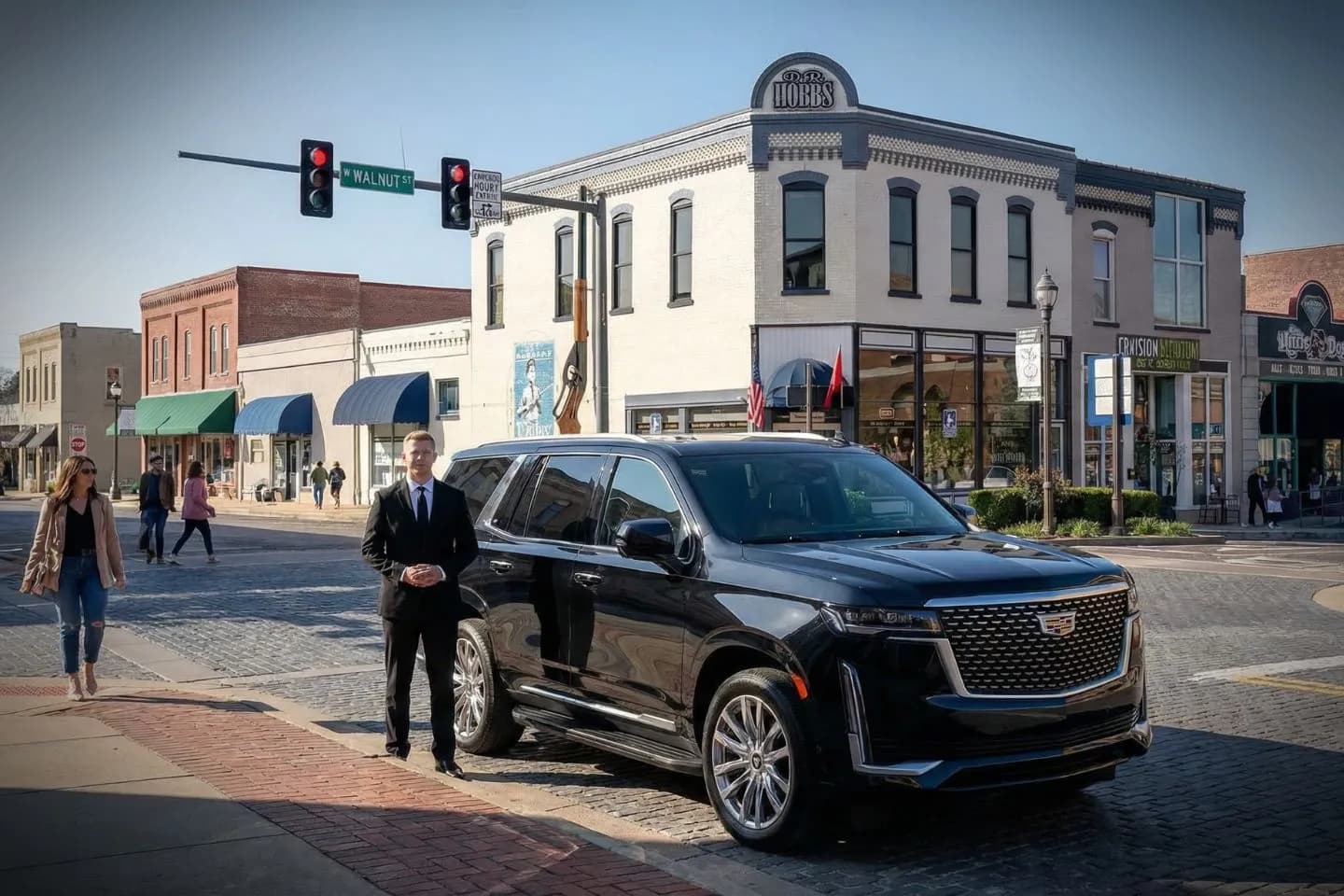 Chauffeur Service in Arkansas, AR Luxury sedan with professional driver from Arkansas, AR Chauffeur Service parked outside downtown office building