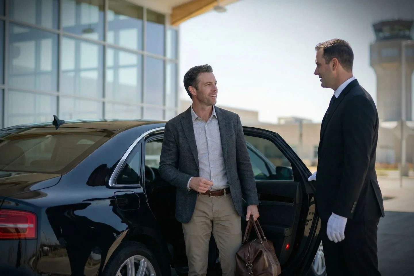 Airport Car Service in Michigan, MI Michigan MI Car Service airport pickup service with professional driver assisting passenger at terminal