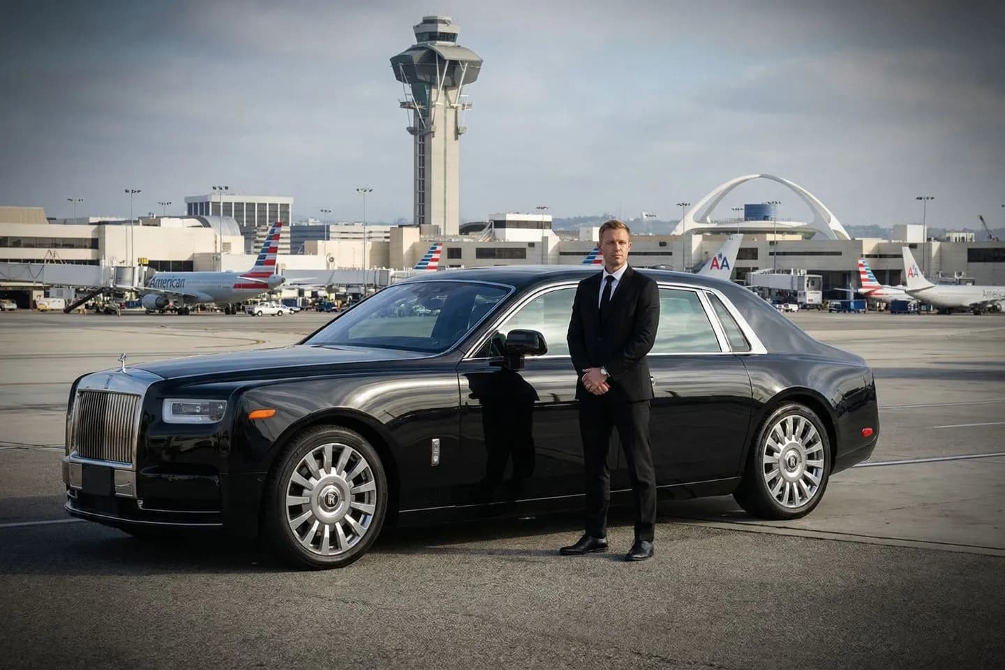 Los Angeles International (LAX) Airport Car Service LBE Car Service chauffeur assisting passenger at LAX terminal