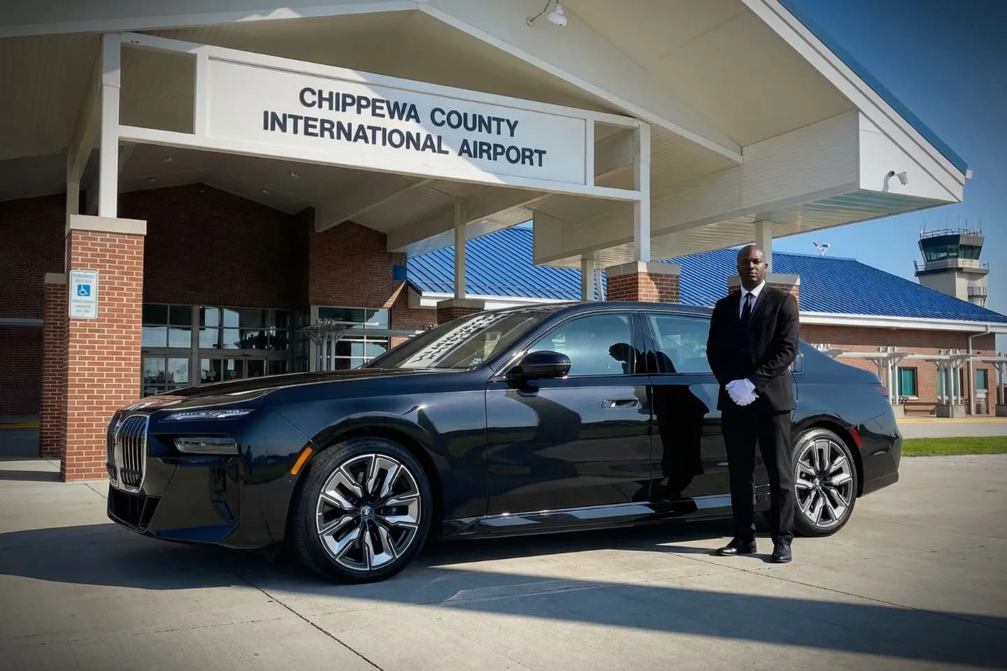 Chippewa County International (CIU) Airport Car Service Luxury black Mercedes Benz S Class at Chippewa County International Airport CIU terminal curbside in Sault Ste Marie Michigan