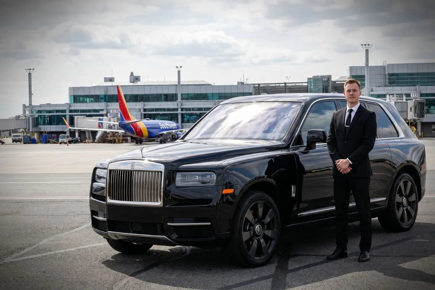 Manchester Boston Regional (MHT) Airport Car Service Black Cadillac Escalade chauffeured car at Manchester Boston Regional airport for ride to Dartmouth College and Hanover
