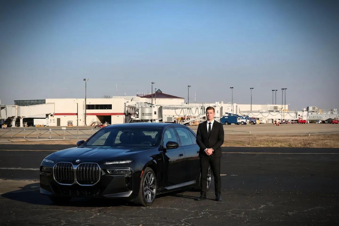 Fayetteville Regional (FAY) Airport Car Service Black luxury sedan parked at Fayetteville Regional Airport terminal curbside in North Carolina