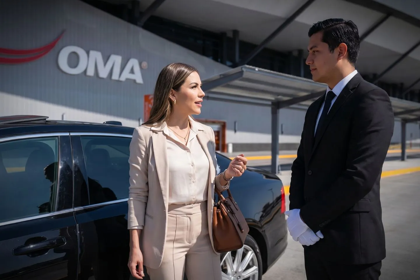 Cuyahoga County (CGF) Airport Car Service Professional chauffeur greeting passenger at CGF FBO lobby private aviation arrivals