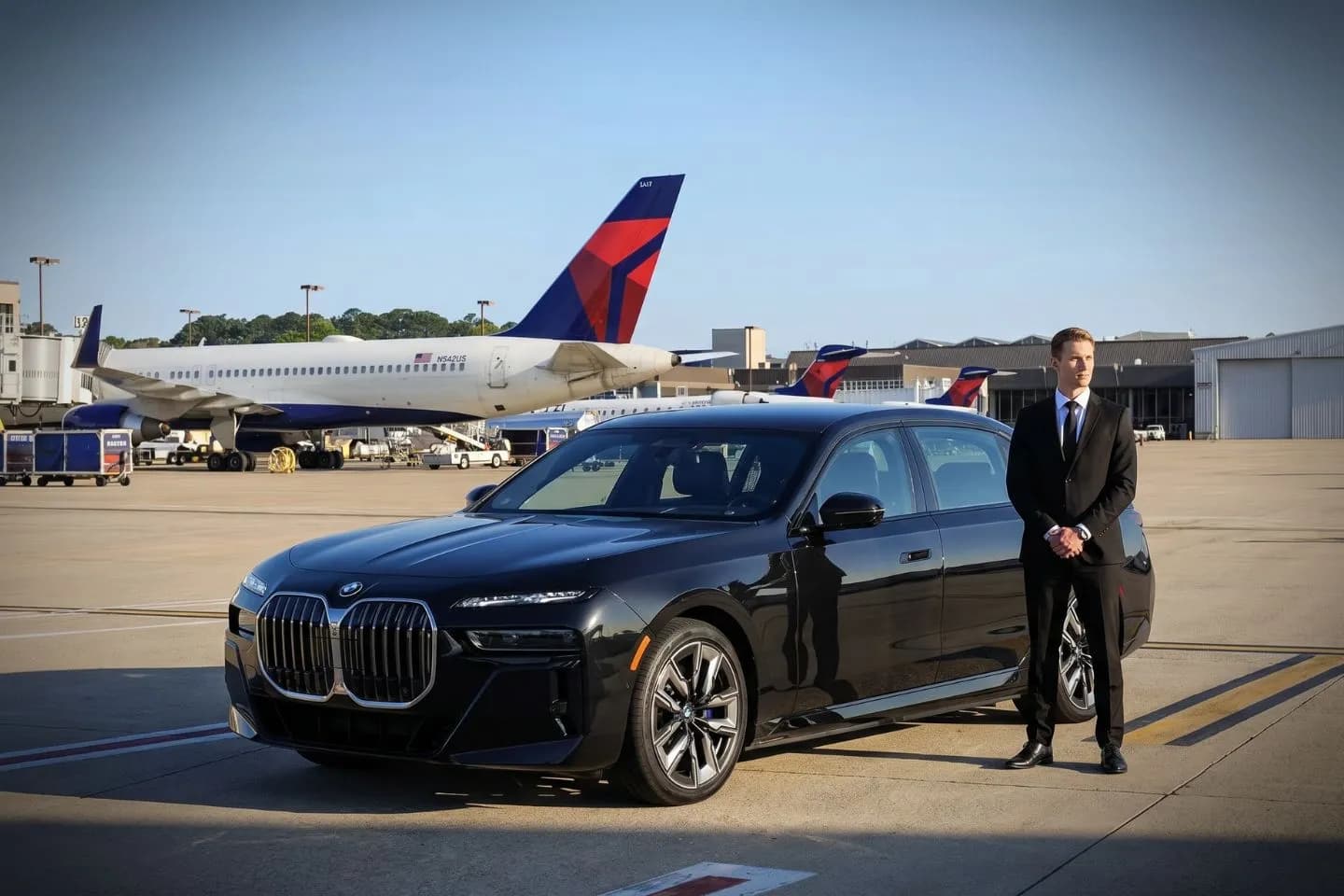 Norfolk International (ORF) Airport Car Service Black luxury sedan parked at Norfolk International Airport terminal curbside in Virginia