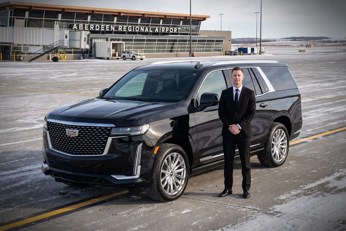 Aberdeen Regional (ABR) Airport Car Service Black Cadillac Escalade chauffeured car at Aberdeen Regional airport for ride to South Dakota pheasant hunting lodges