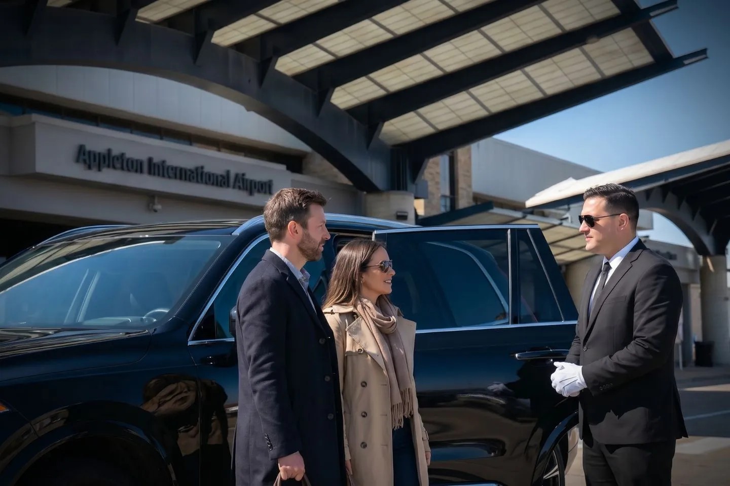 Appleton International (ATW) Airport Car Service Professional chauffeur greeting passenger at ATW baggage claim arrivals area