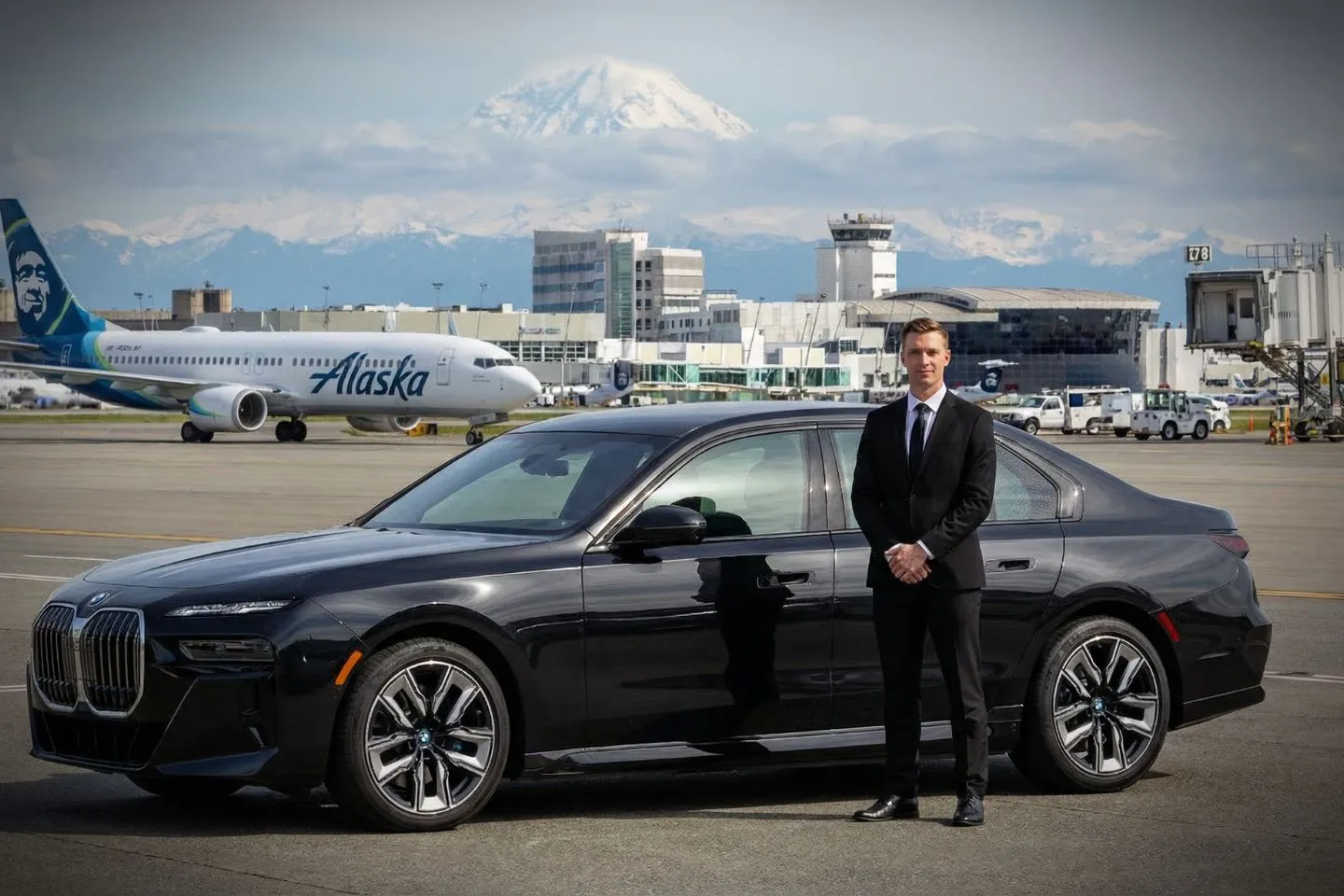 Seattle-Tacoma International (SEA) Airport Car Service Black luxury sedan parked at Seattle-Tacoma International Airport terminal curbside