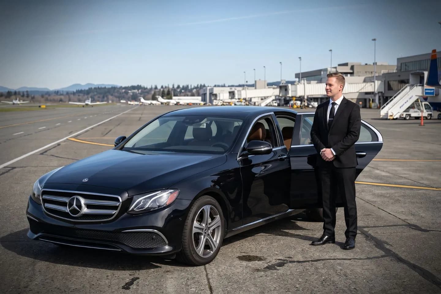 Renton Municipal (RNT) Airport Car Service Black luxury sedan parked at Renton Municipal Airport FBO entrance in Renton Washington