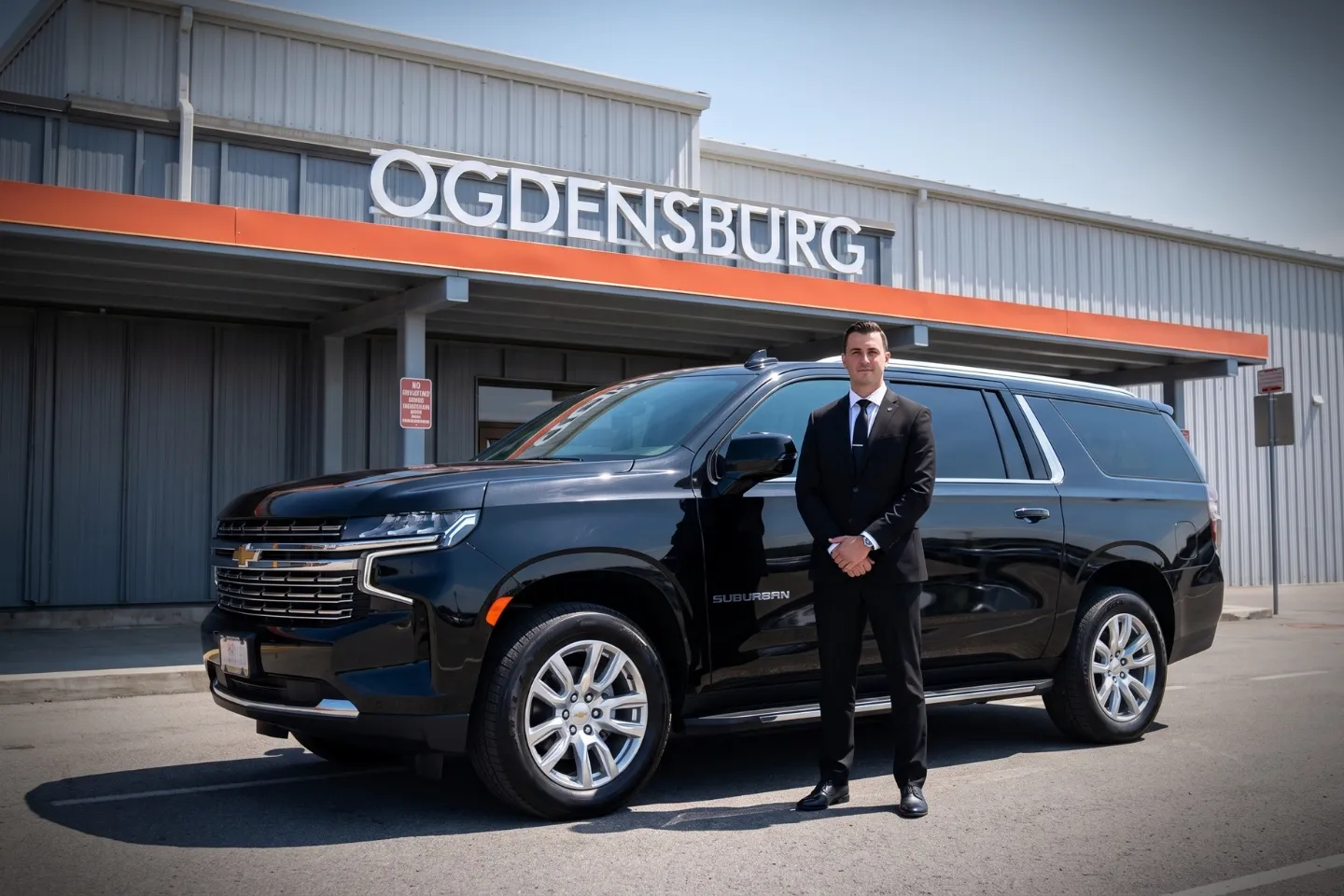 Ogdensburg International (OGS) Airport Chauffeur Service Chauffeur driven black sedan parked outside Ogdensburg International Airport terminal