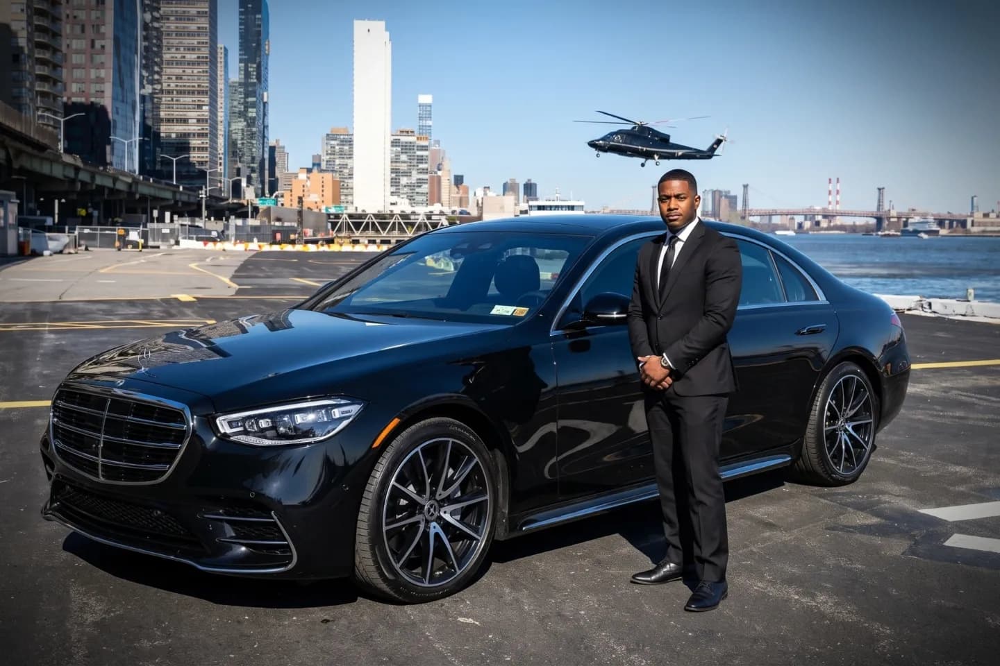 New York East 34th Street Heliport (TSS) Airport Chauffeur Service Black luxury sedan parked at the East 34th Street Heliport entrance in Manhattan