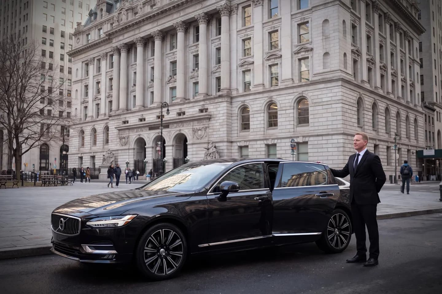 Car Service near Civic Center, NY 1Suited chauffeur opening an executive black sedan door near Civic Center, NY