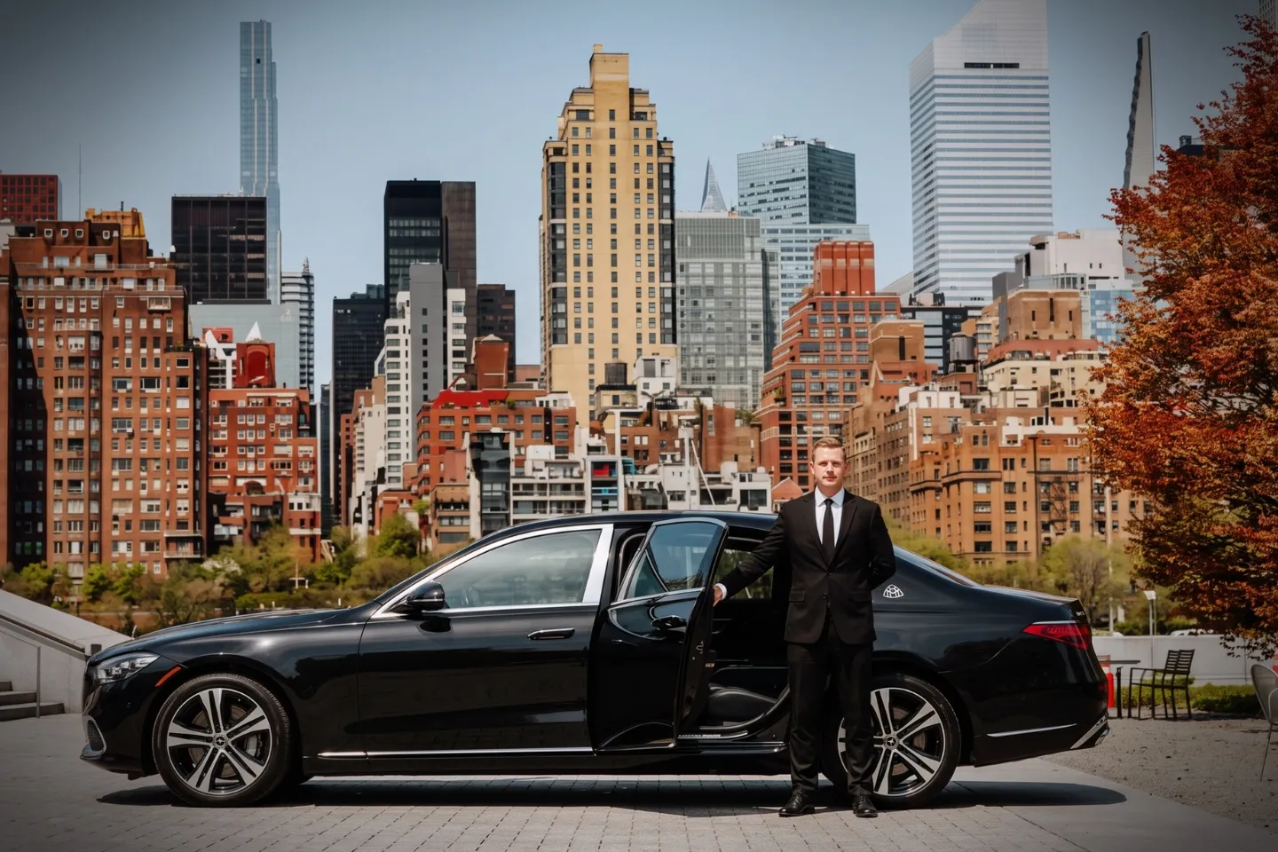 Car Service in Roosevelt Island, Manhattan, NY Black sedan parked with the Roosevelt Island tramway in the background