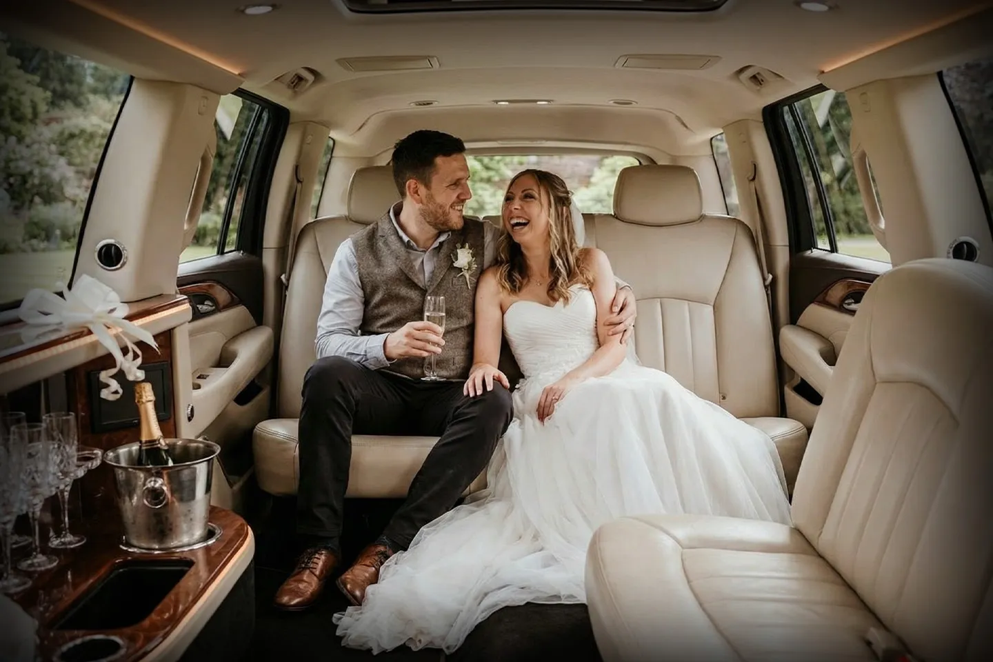 Luxury wedding limousine with professional chauffeur ready for bride and groom