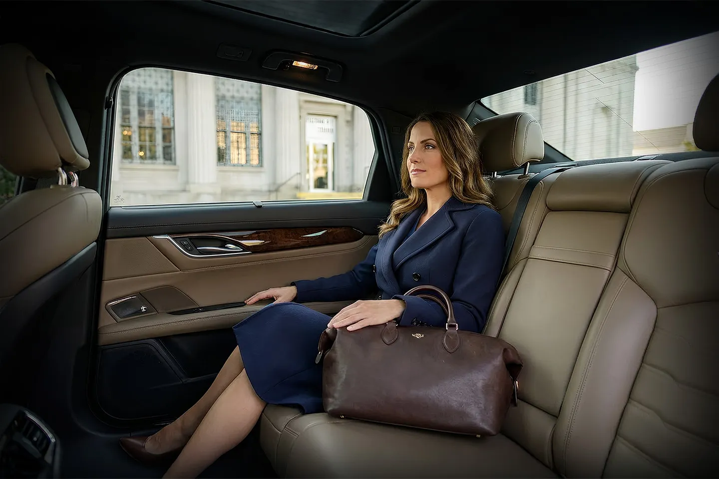 Professional chauffeur assisting passenger into premium vehicle in Fulton NY chauffeur service setting