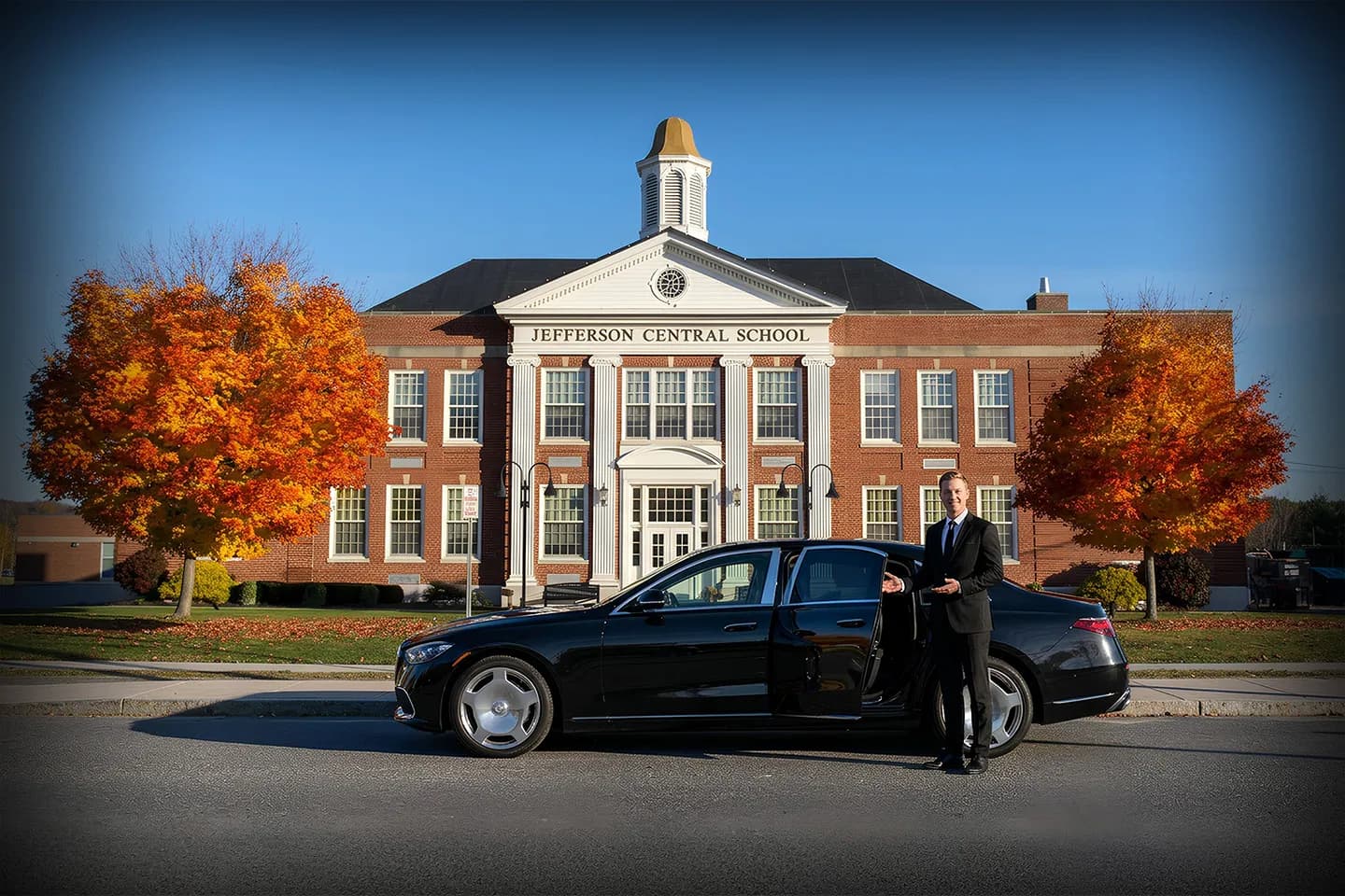 Chauffeur opening car door in Jefferson NY for premium private car service client