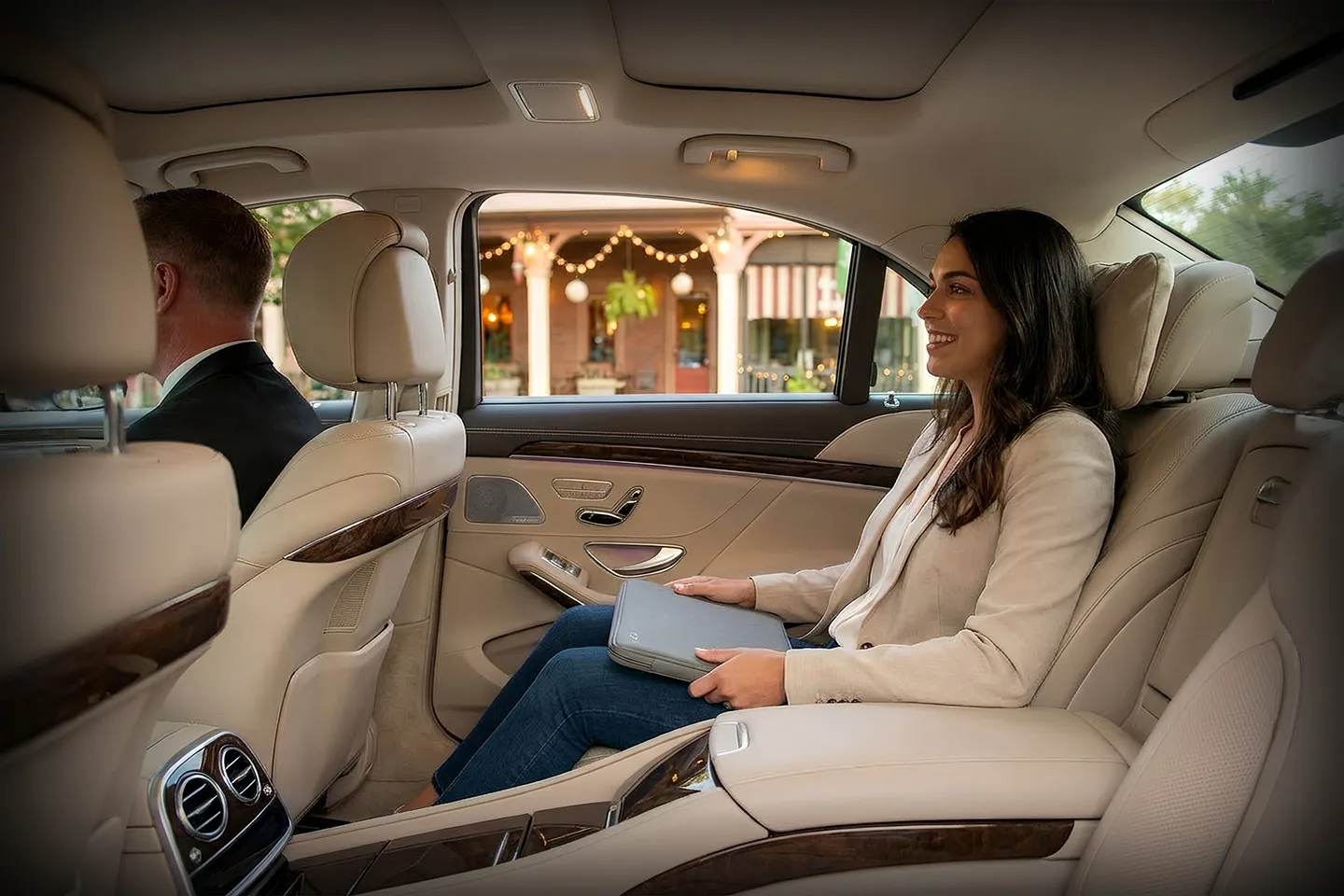 Professional driver from Saratoga NY chauffeur service assisting passenger with luggage at airport pickup