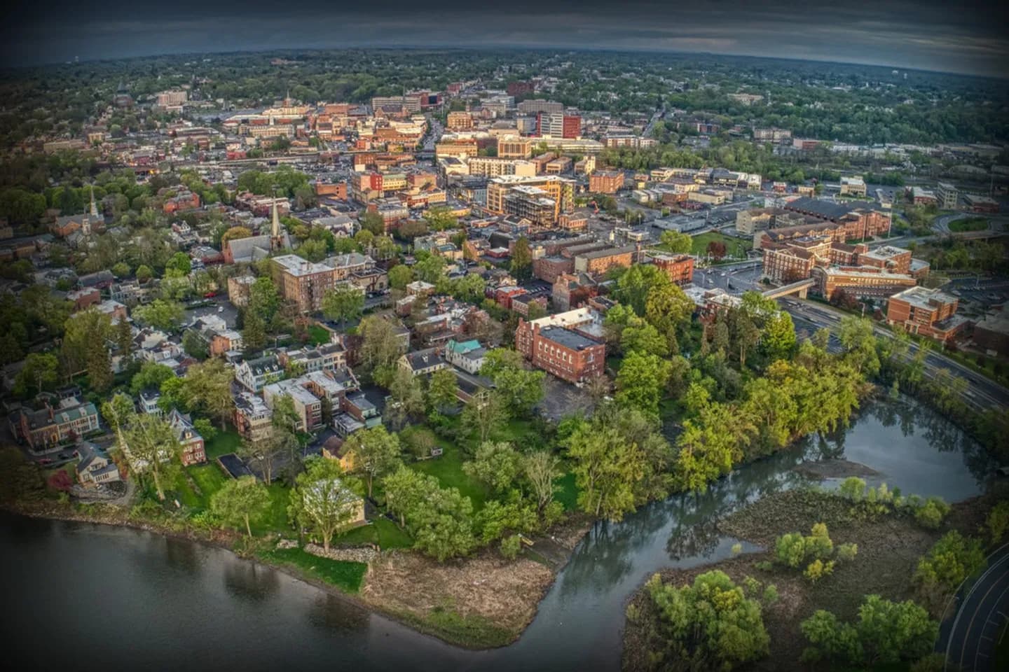 Professional driver from Schenectady, NY Chauffeur Service assisting passenger at airport pickup