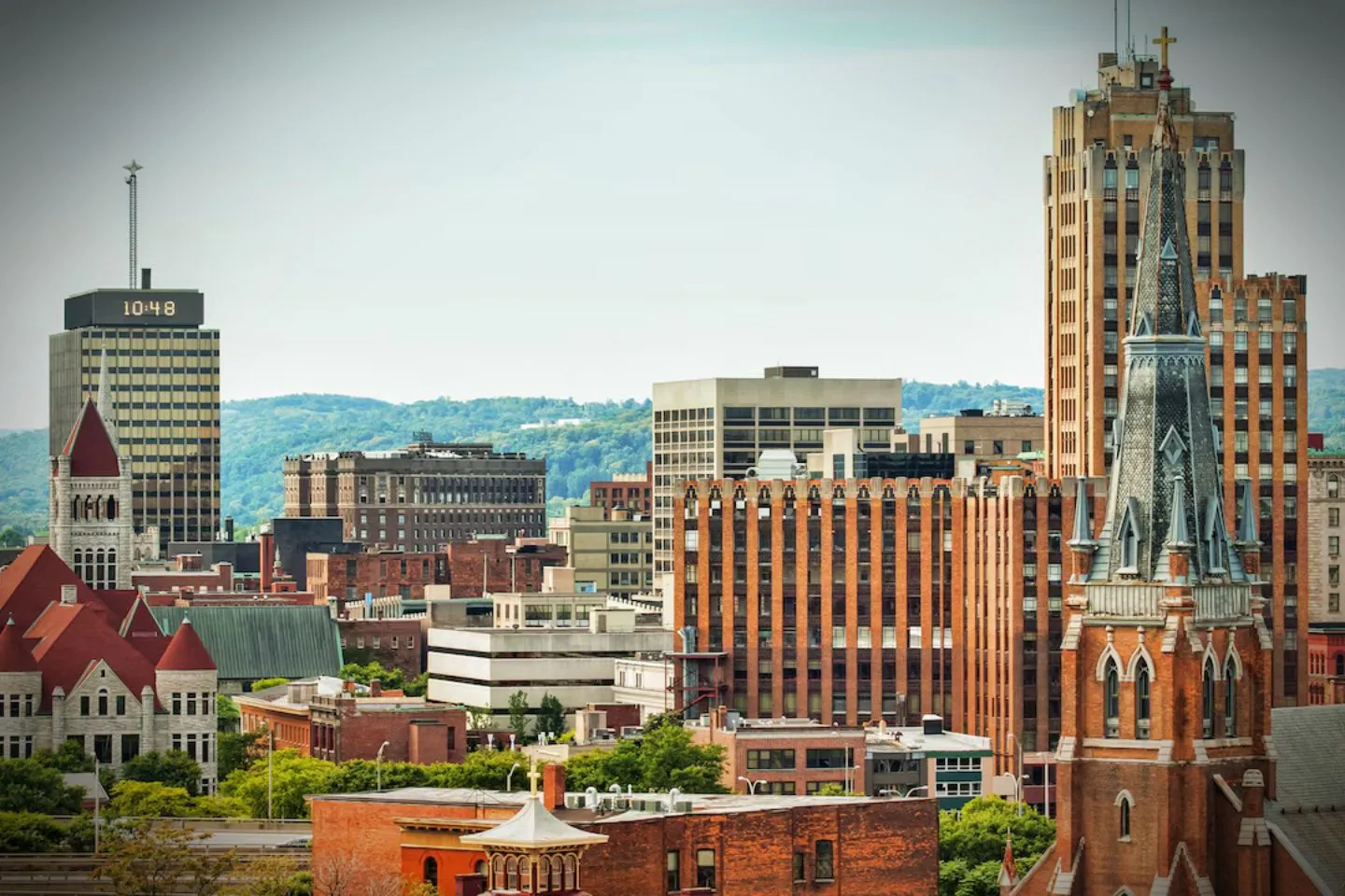 Chauffeur assisting passenger with luggage using Sullivan NY chauffeur service at local hotel