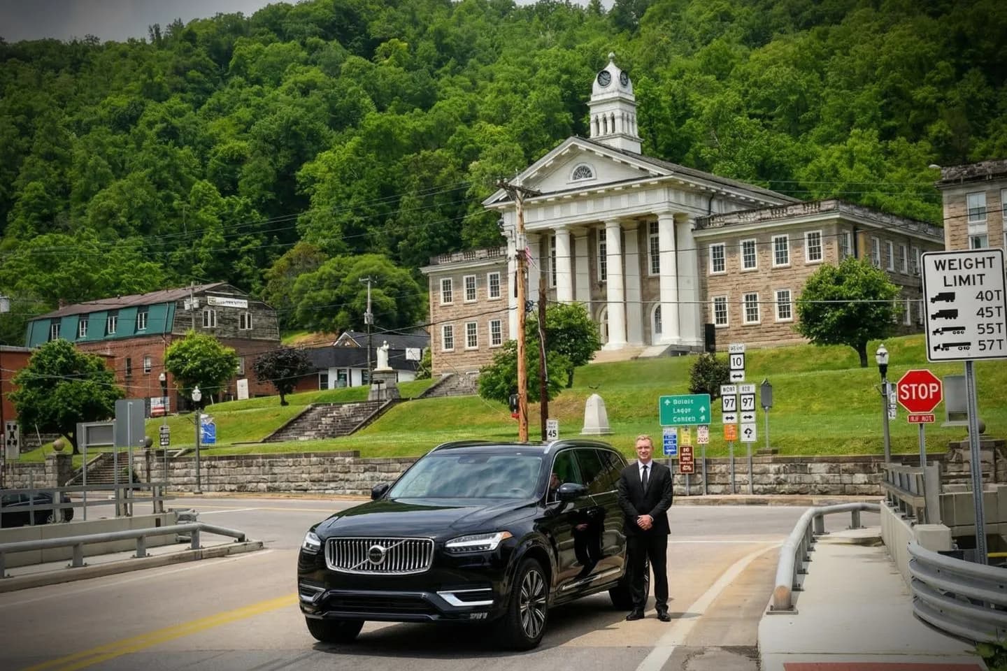 Chauffeur Service in Wyoming, NY Chauffeur assisting client with luggage in Wyoming NY premium car service